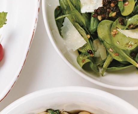 Spinach salad with pecorino, pine nuts, and currants
