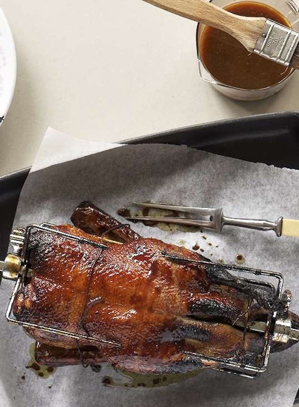 Spit-roasted duck with orange and pomegranate molasses glaze