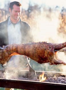 Spit-roasted whole spring lamb overcome by garlic
