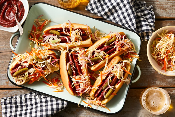 Split BBQ hot dogs with crunchy-tangy slaw