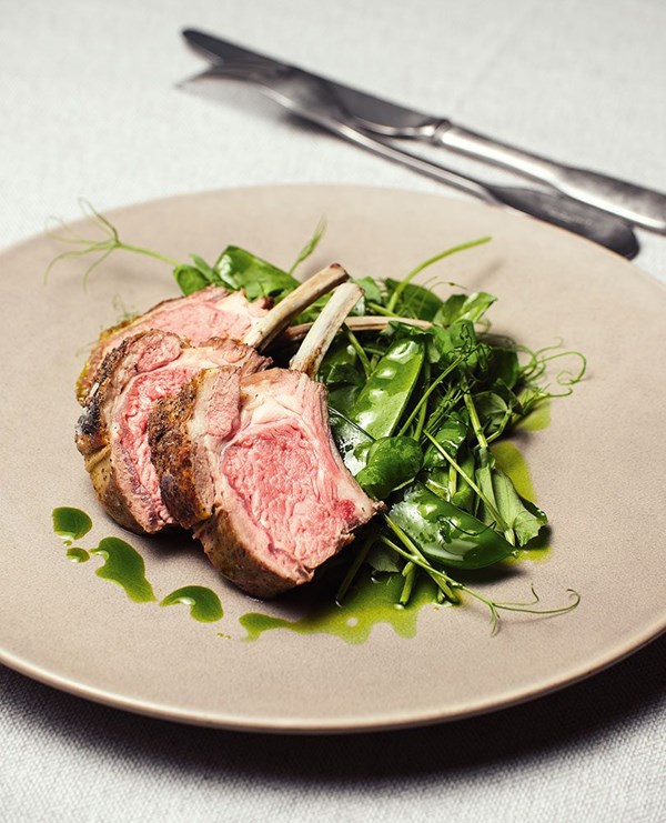 Spring lamb rack with mixed peas and chive and garlic oil