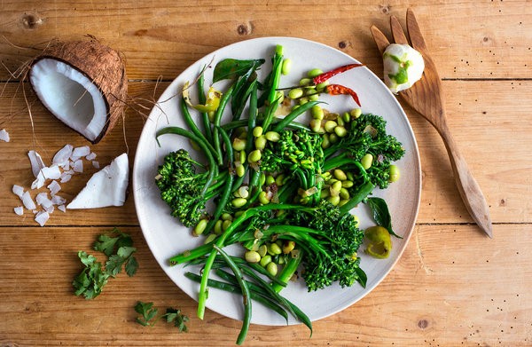 Sprouting broccoli and edamame salad with curry leaves and coconut