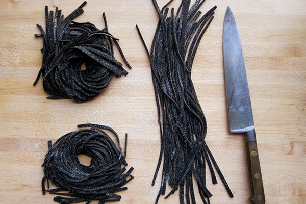 Squid ink chitarra with sea urchin, tomatoes, and chiles