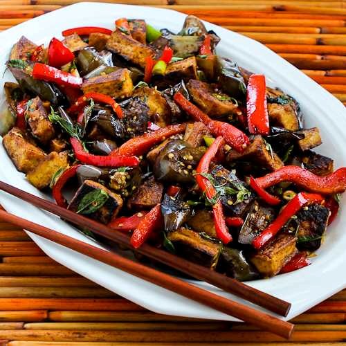Sriracha-spiced stir-fried tofu with eggplant, red bell pepper, and Thai basil