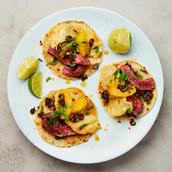 Steak and cheese tacos with orange and jalapeño