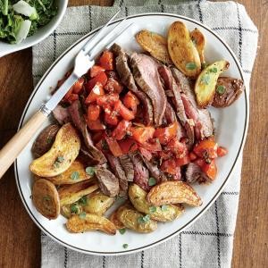 Steak and tomatoes with herb-roasted potatoes