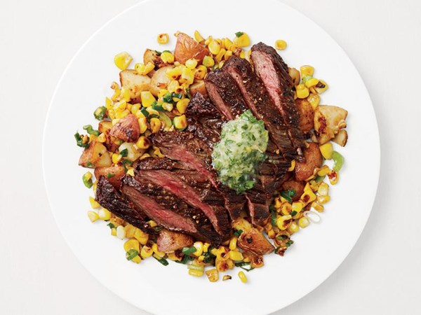 Steak, corn and potatoes with garlic butter 