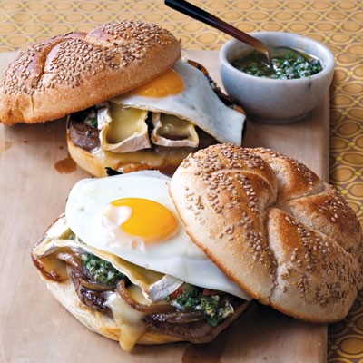 Steak sandwich with onions, Camembert, fried egg, and chimichurri