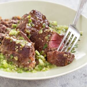 Steak tips with tomatillo salsa and refried beans