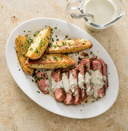 Steak with lemon-parsley potato wedges and blue-cheese sauce