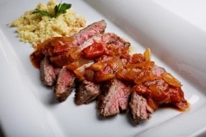 Steak with onion and tomato sauce