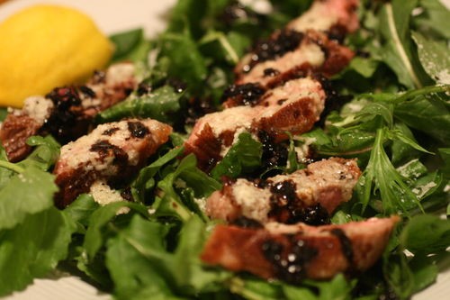 Steak with Parmesan butter, balsamic glaze, and arugula
