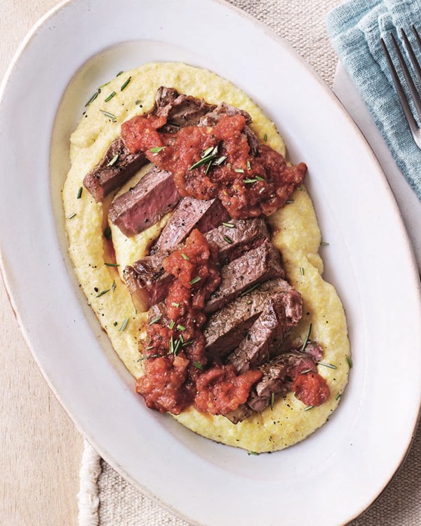 Steak with polenta and tomato & caper sauce