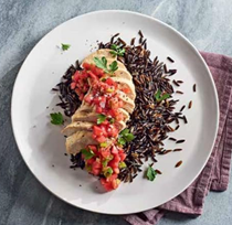 Steamed chicken breasts on wild rice with gingered tomato relish
