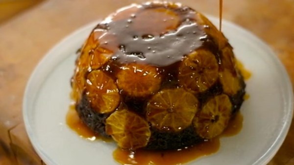 Steamed chocolate and clementine sponge with orange sauce