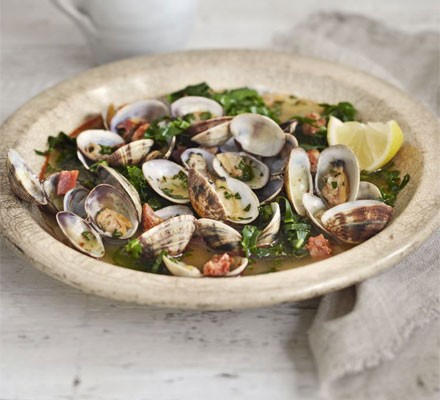 Steamed clams in saffron and spring green broth