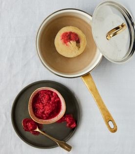 Steamed coconut pudding with raspberry sauce
