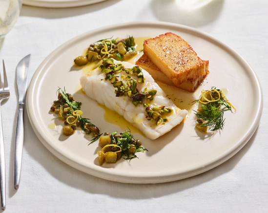 Steamed fish with pistachio butter, served with potato pavé