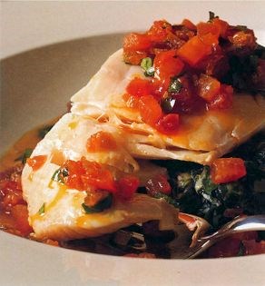Steamed halibut on spinach with soured lime cream and spicy curry dressing