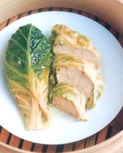 Steamed herb and garlic chicken wrapped in leaves