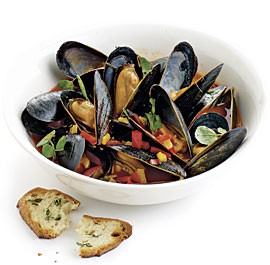 Steamed mussels with bell peppers, watercress, and herbed toasts