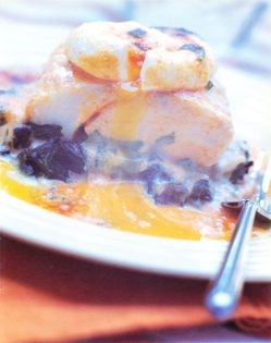 Steamed smoked haddock on spinach with a warm poached egg, glazed with a sweet pepper Béarnaise sauce