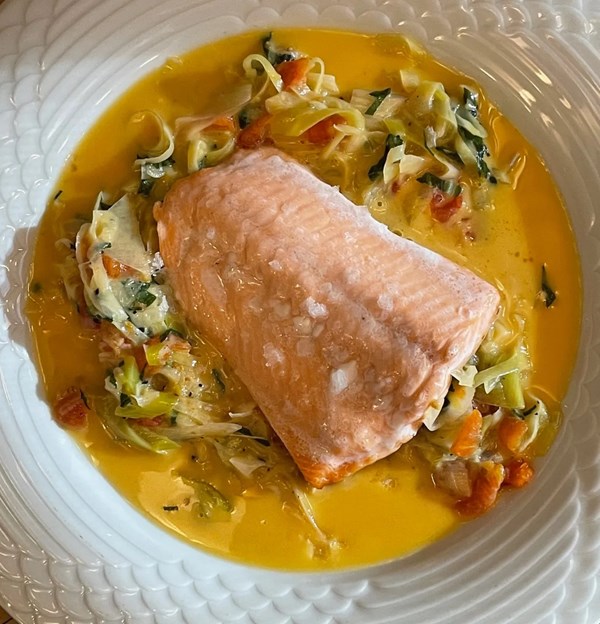 Steelhead trout with leek-tomato-basil cream sauce