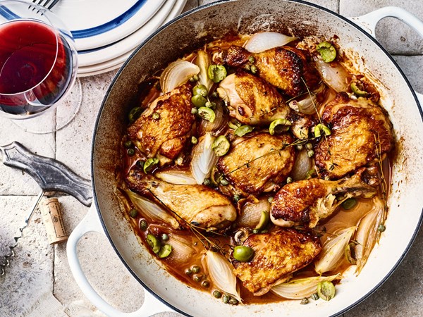 Stewed chicken legs and thighs with fresh herbs and olives