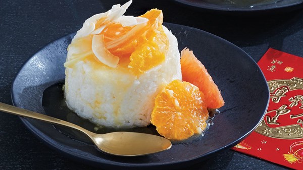 Sticky coconut rice "cake" with ginger-orange flambé