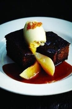 Sticky date pudding with poached autumn fruits and clotted cream