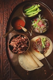 Sticky shredded duck with clementine and chilli sauce, pancakes and trimmings