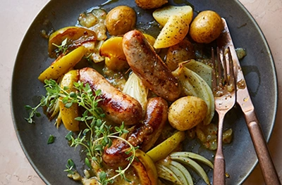 Sticky spiced sausage & plum traybake