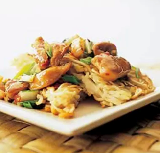 Stir-fried chicken with bok choy and crispy noodle cake