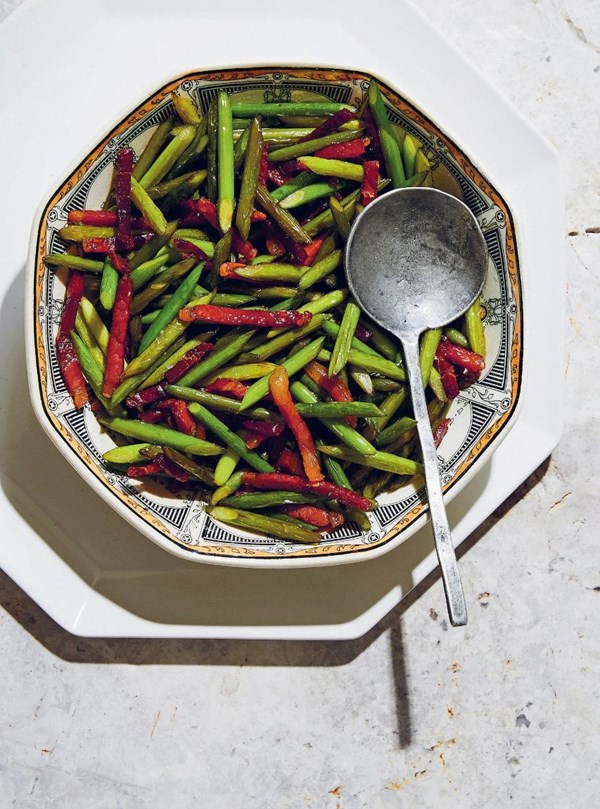 Stir-fried garlic shoots with jamón
