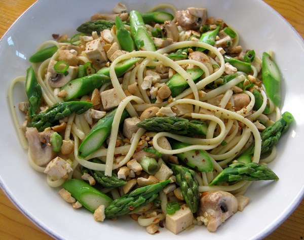 Stir-fried noodles with asparagus, mushrooms, tofu, and cashews