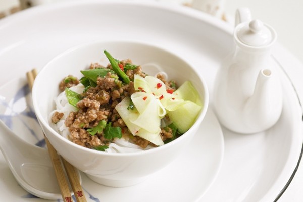 Stir-fried pork and pickled cucumber on rice noodles