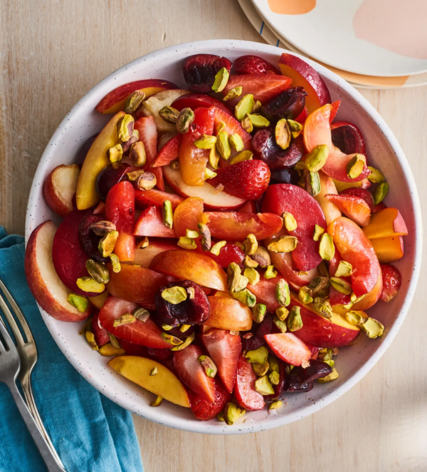 Stone fruit salad with strawberries and pistachios