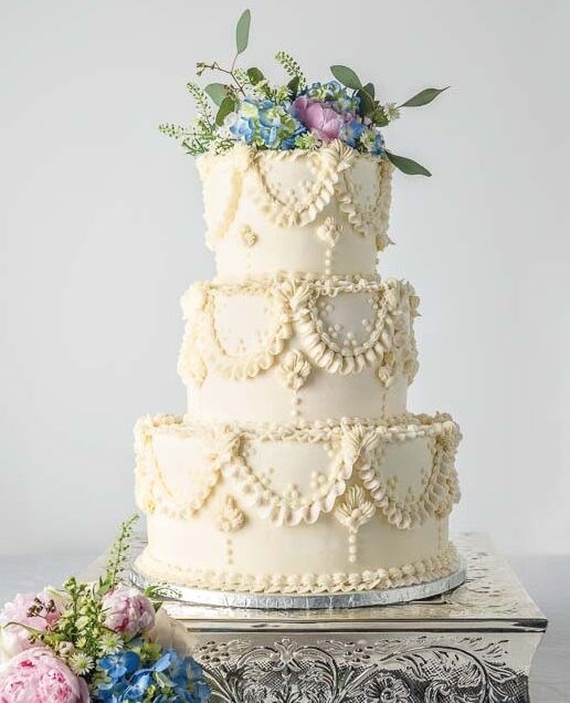Strawberries and cream wedding cake [vanilla white cake; vanilla American buttercream; vanilla simple syrup; strawberry cream filling]