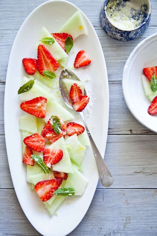 Strawberries and honeydew melon with lemon sugar & mint
