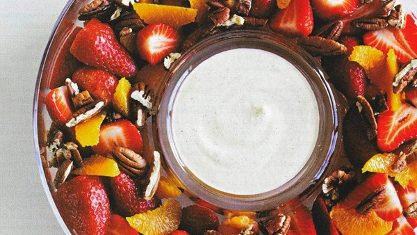 Strawberries, orange and pecans with egg and rum sauce