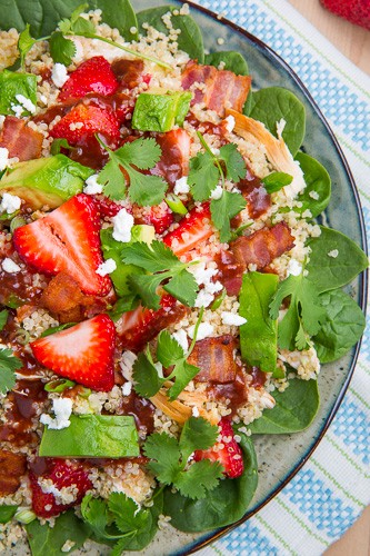 Strawberry BBQ chicken spinach and quinoa salad with bacon, avocado and goat cheese