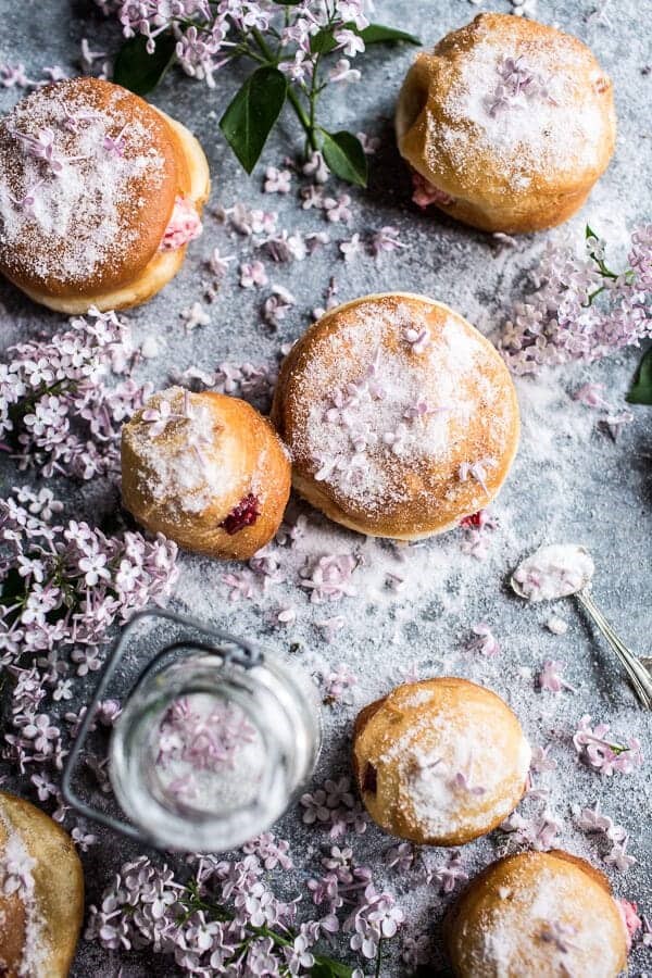 Strawberry jelly and vanilla cream brioche doughnuts with lilac sugar