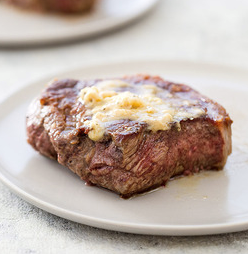 Strip steaks with herb-horseradish butter