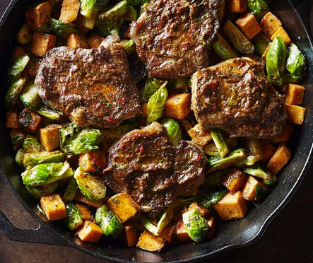 Strip steaks with smoky cilantro sauce & roasted vegetables