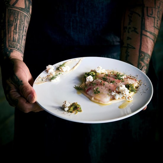 Striped bass crudo with popccorn crema and shishito vinaigrette