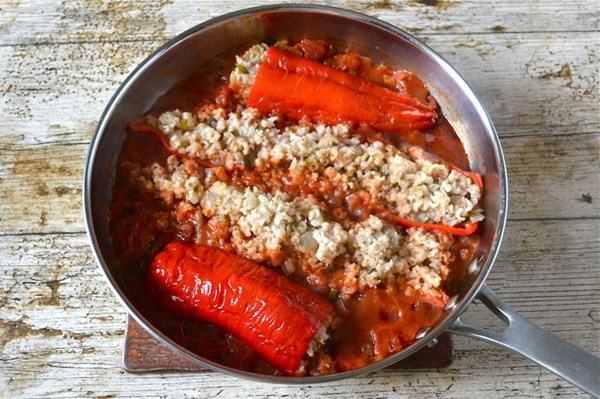 Stuffed red peppers in tomato sauce