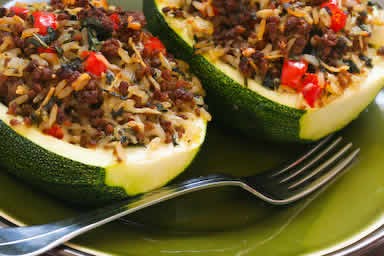 Stuffed zucchini with brown rice, ground beef, red pepper, and basil