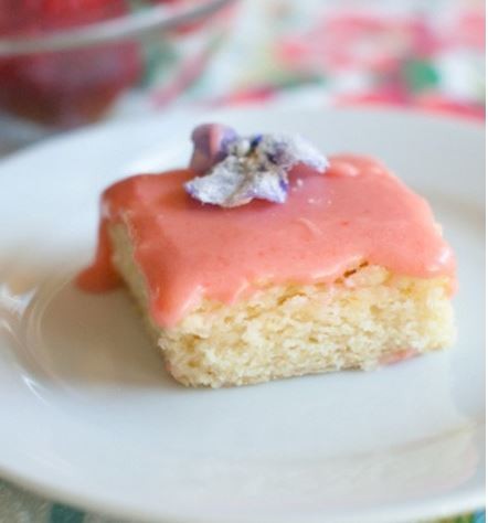 Sugar cookie bars with strawberry glaze and sugared flowers