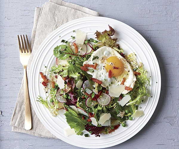 Summer salad with peas, Parmesan, fried egg, and bacon
