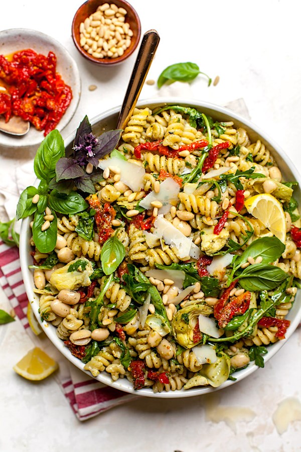 Sun-dried tomato, white bean, and artichoke pesto pasta salad